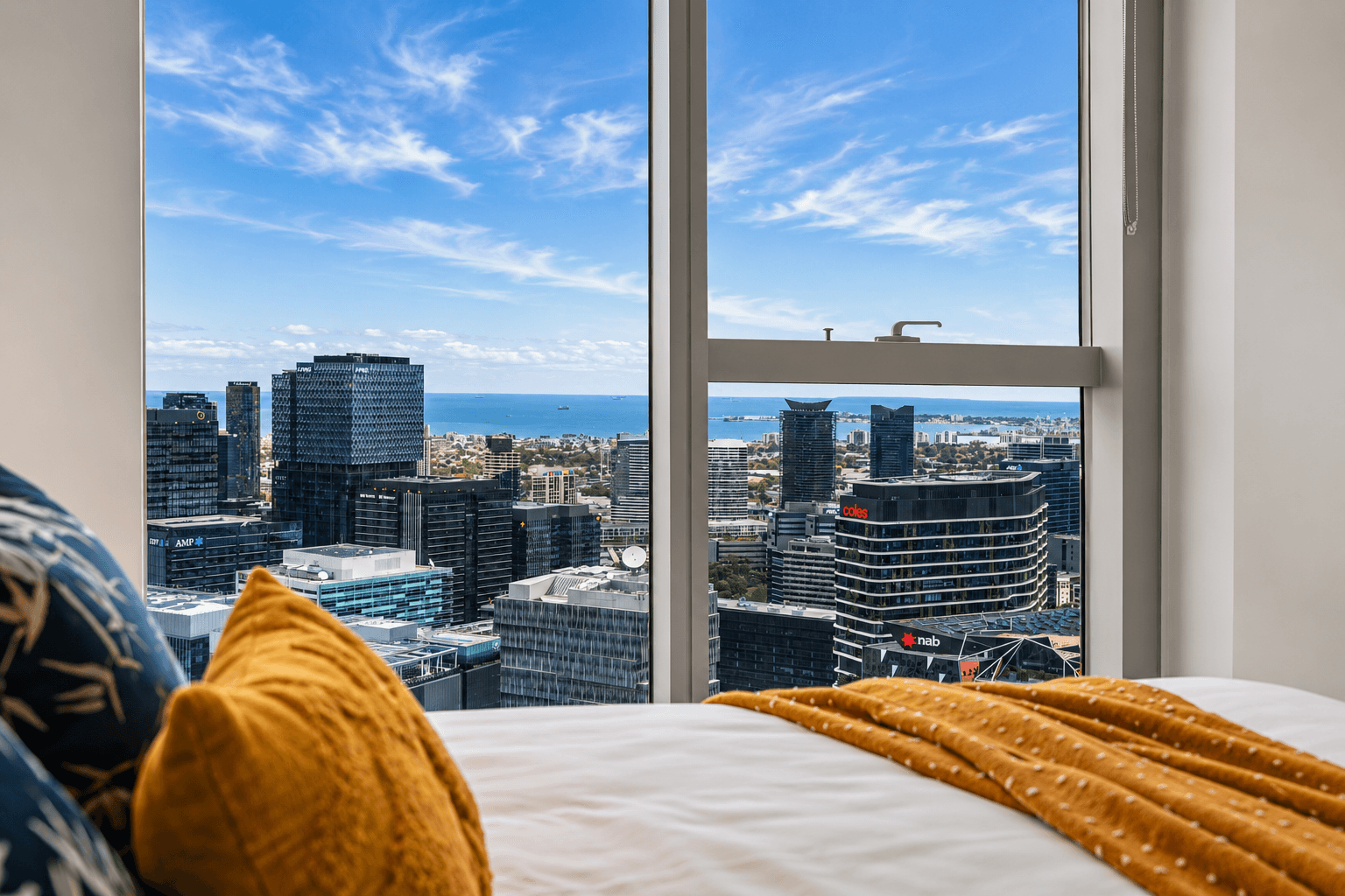 Master bedroom with floor-to-ceiling panoramic views over Melbourne and Port Phillip Bay