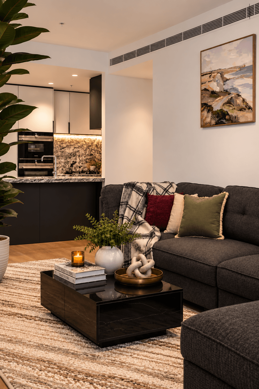 Staged living room lounge and open kitchen layout with warm designer lighting